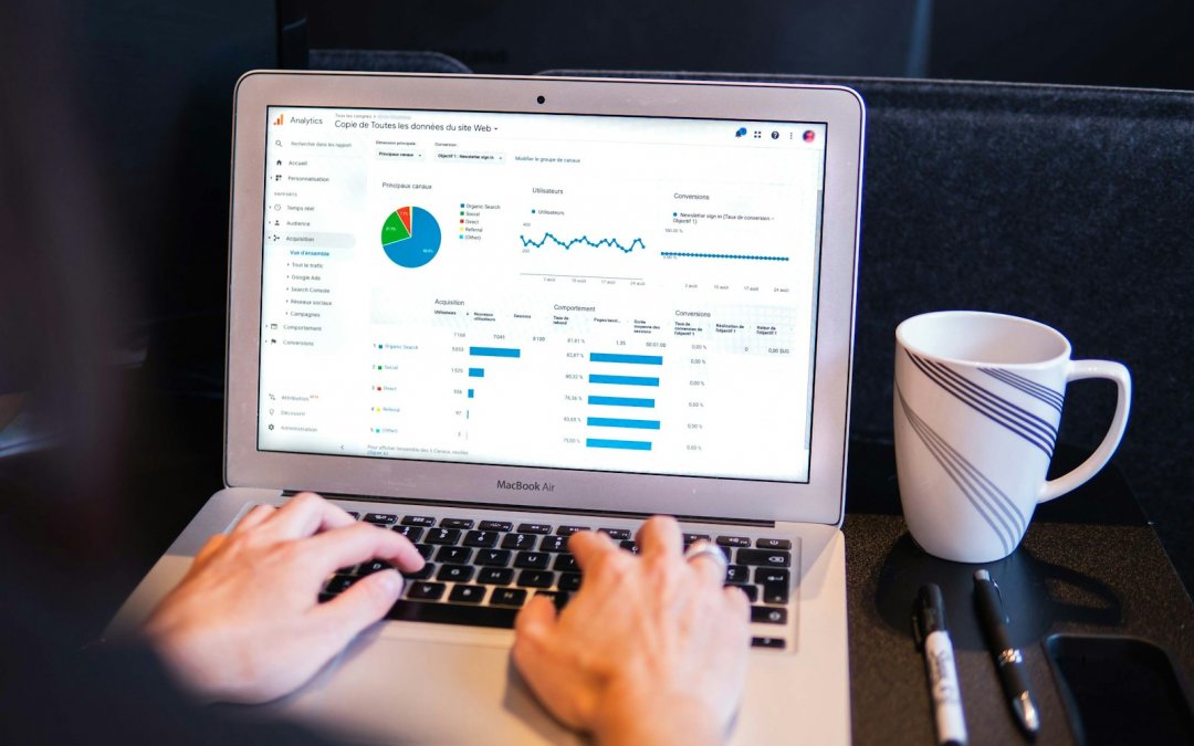 person using macbook pro on black table